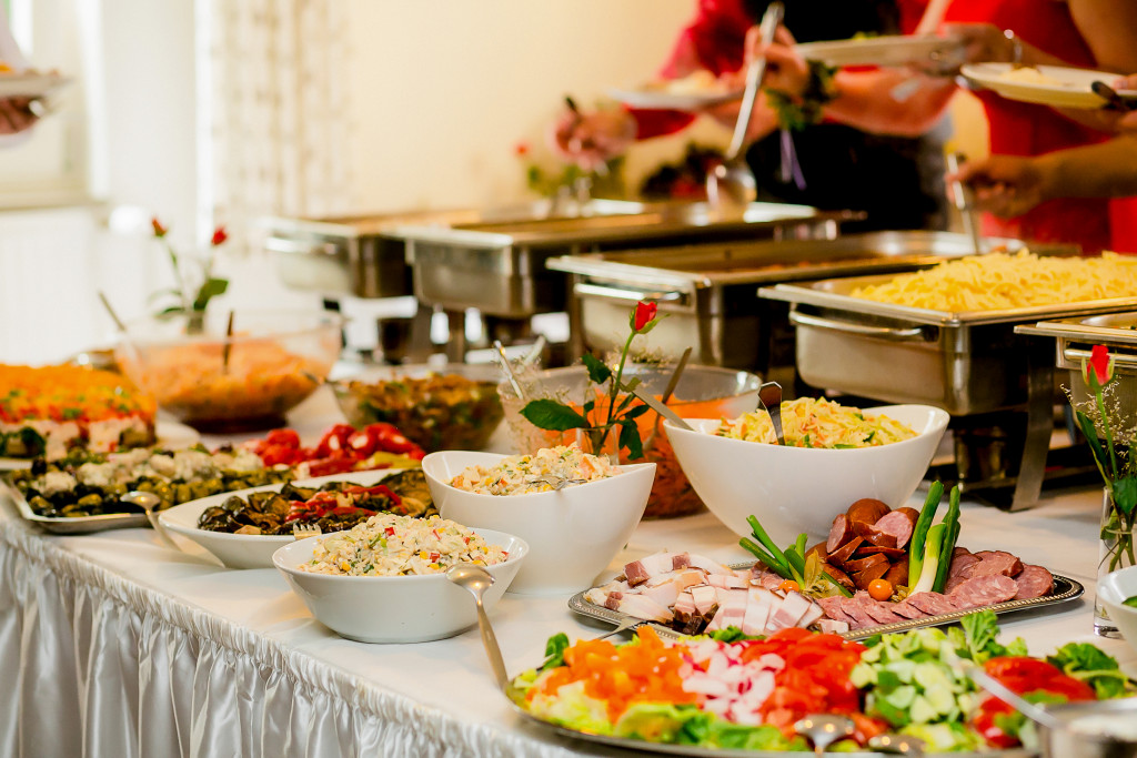 catering table with different cuisines and food for the guests