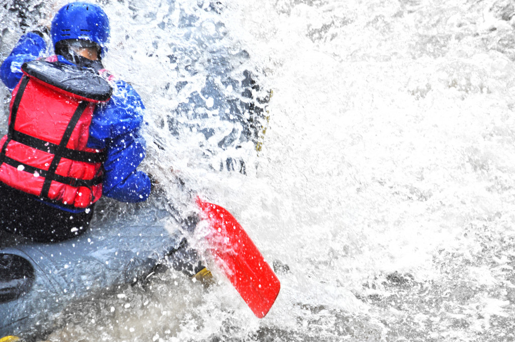 A whitewater rafter in action