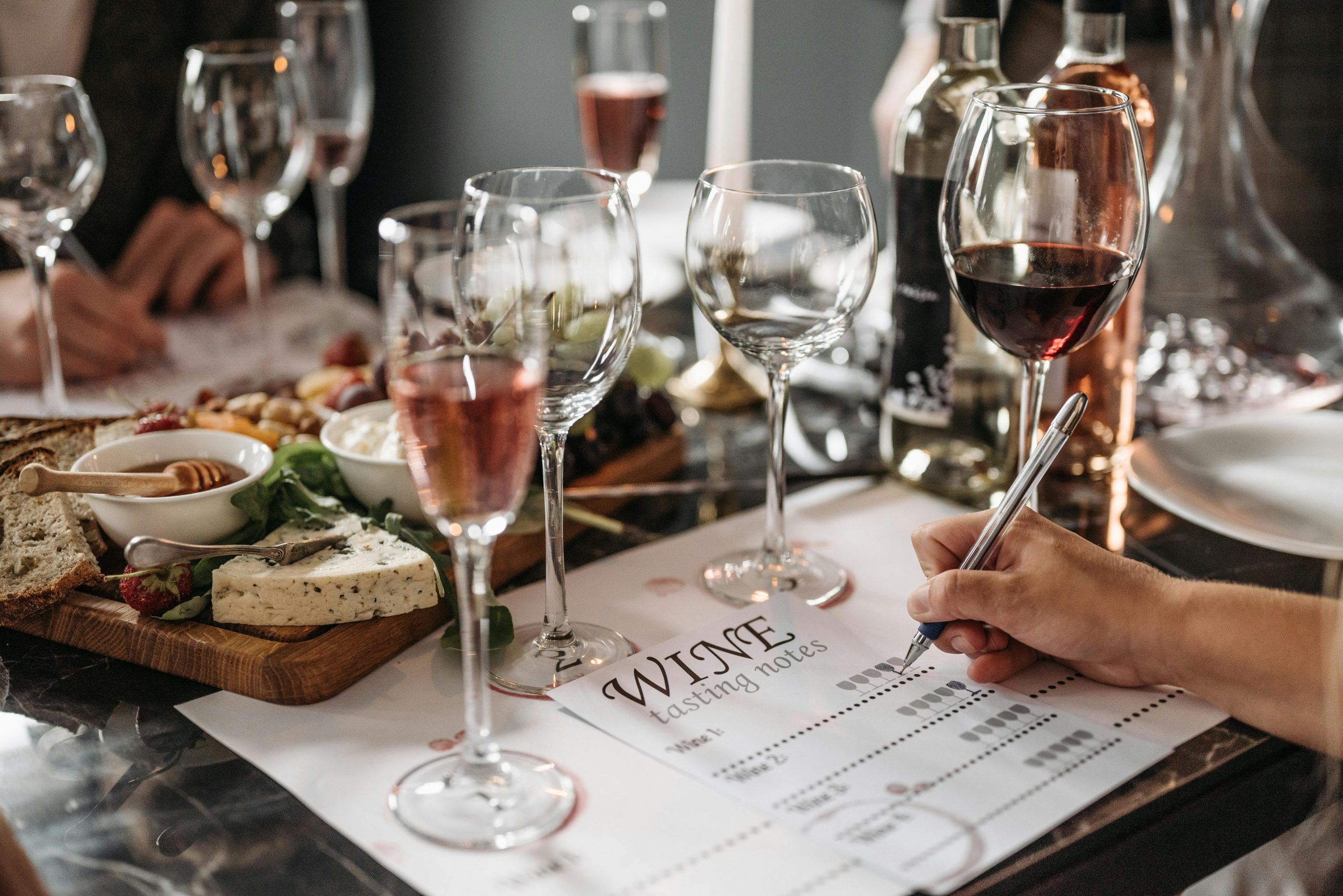 woman checking off boxes on a wine tasting notes sheet